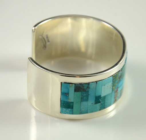 Sterling Silver and Natural Turquoise are expertly inlaid this this wonderful bracelet by Navajo artist, Tommy Jackson.